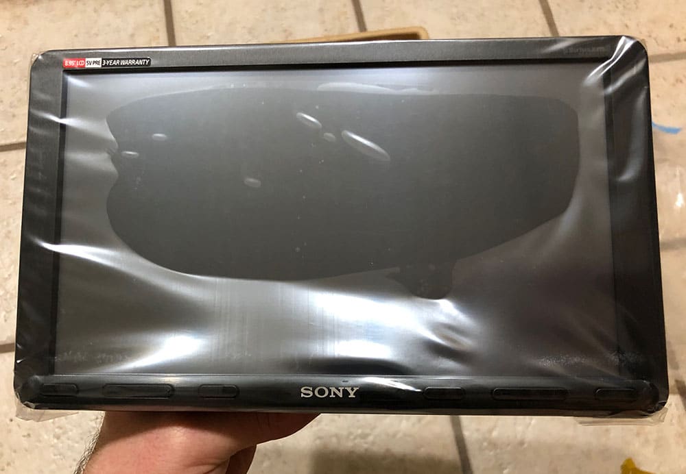 Sony XAV-AX8000 unbox screen in hand